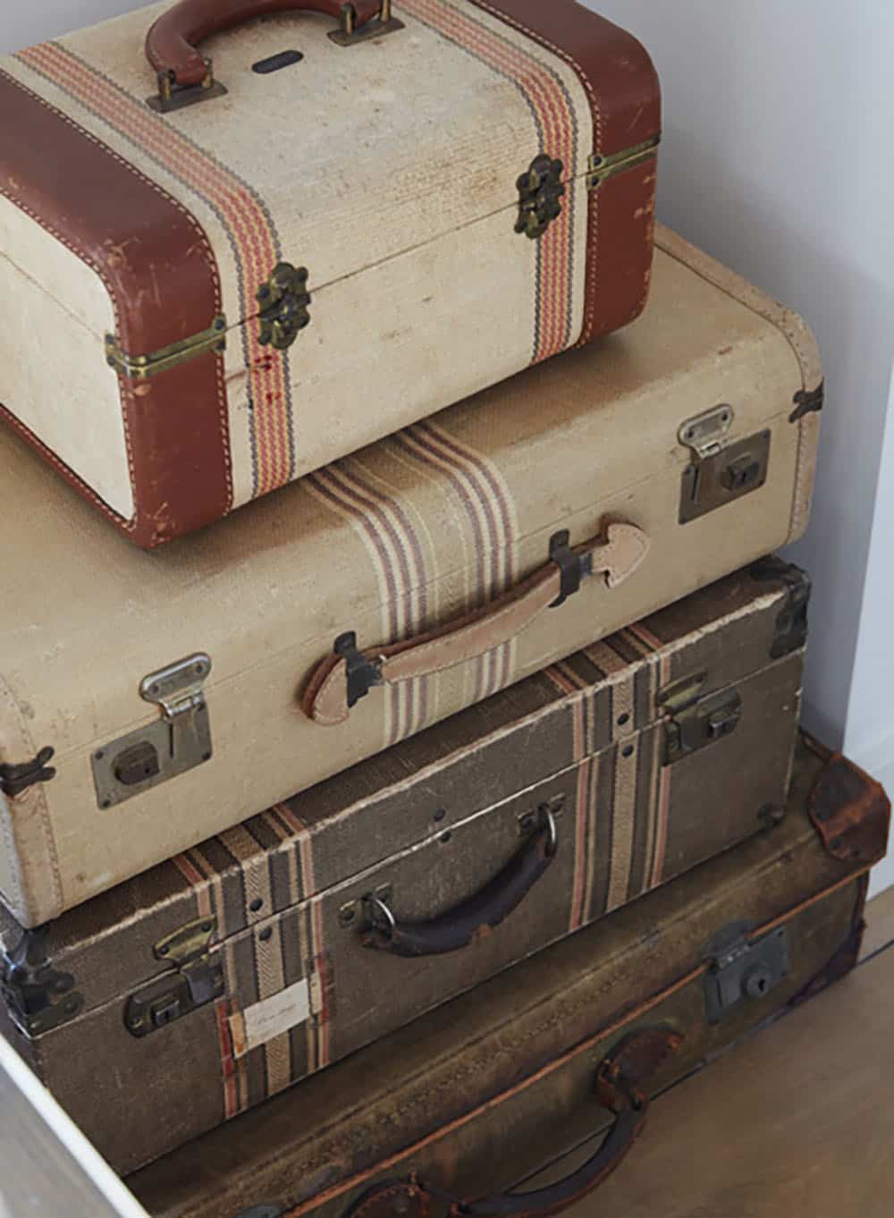 urban farmhouse living room with stacked vintage suitcases 