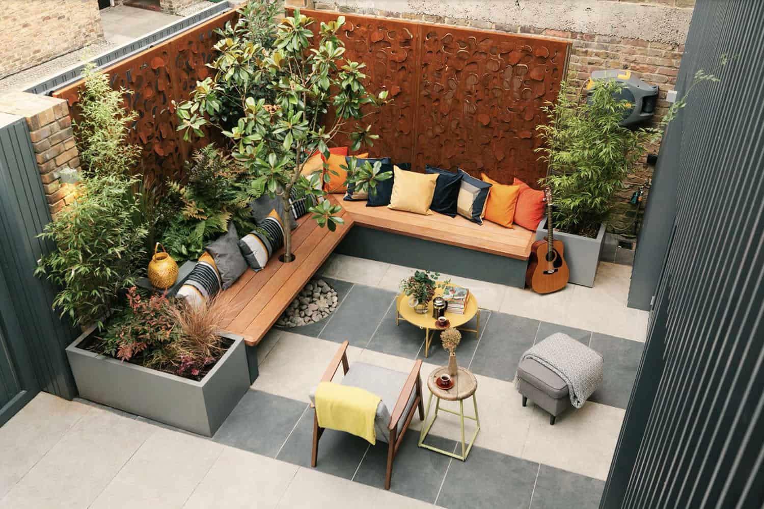 small courtyard patio seating area with a garden backdrop