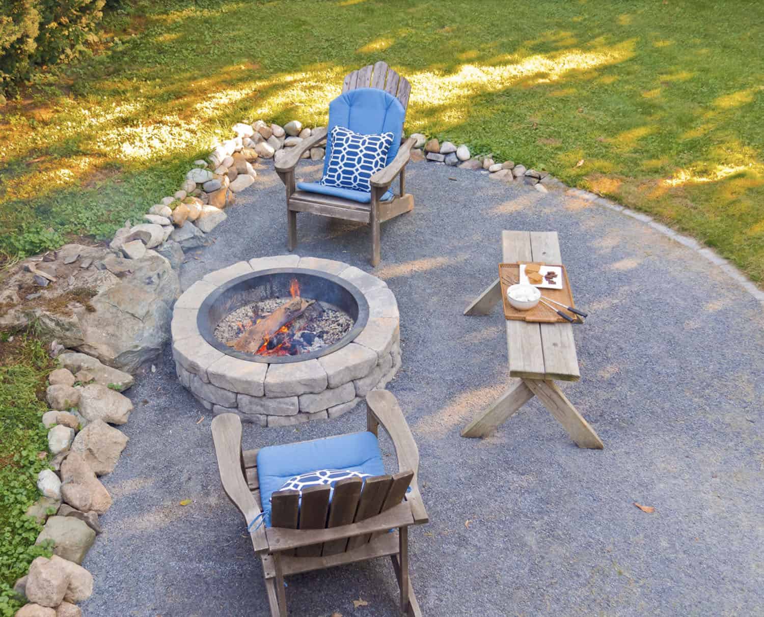 beach style patio with a fire pit and Adirondack chairs