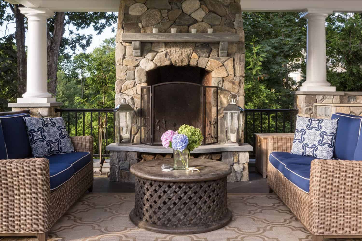 small patio with a fireplace and small round table with chairs