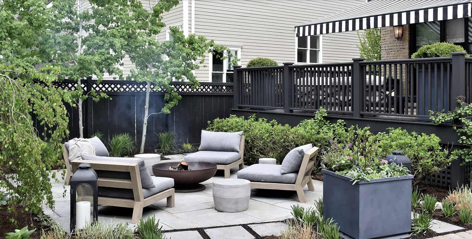 patio with outdoor furniture surrounded by gardens