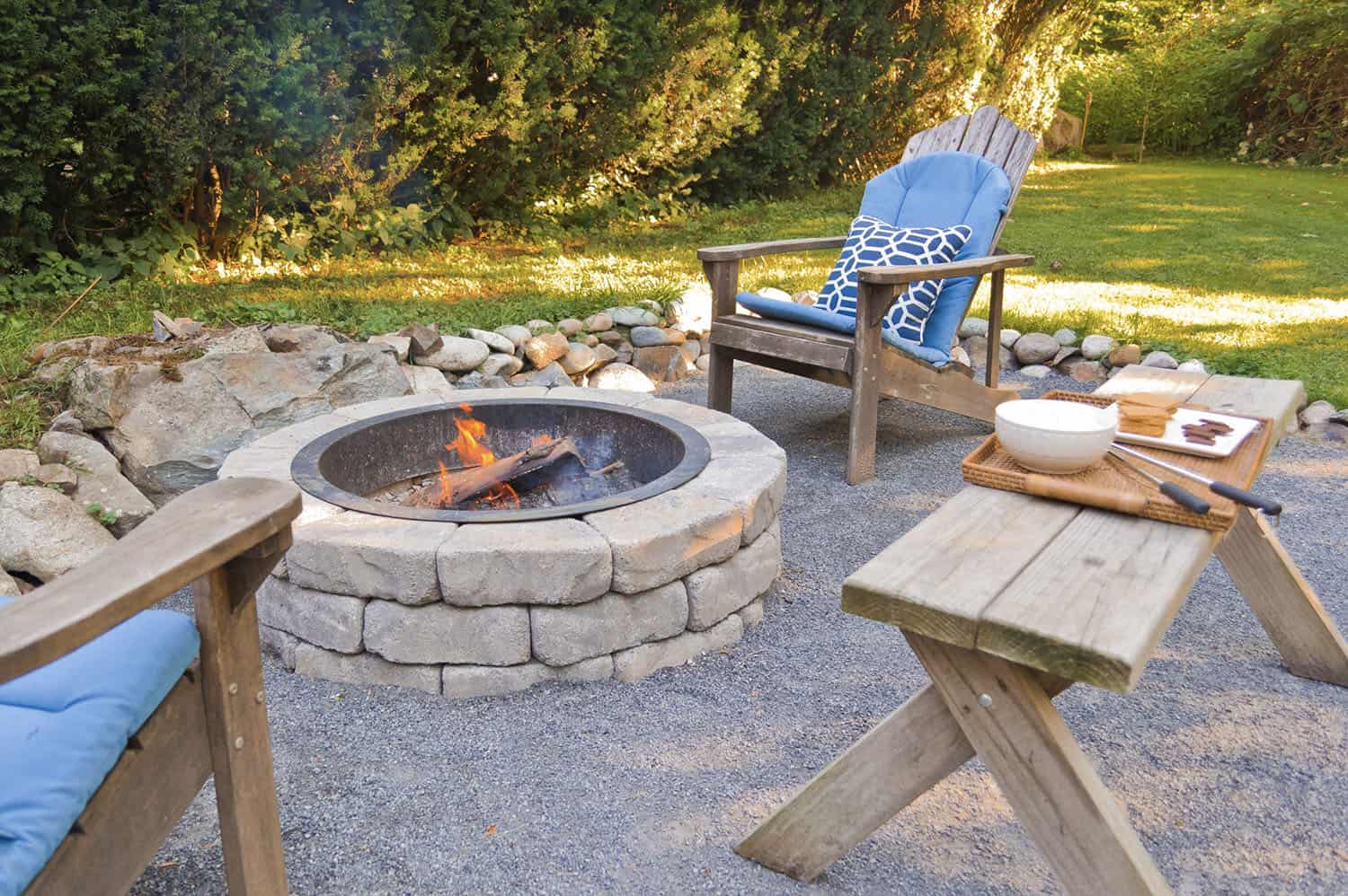 beach style patio with a fire pit and Adirondack chairs