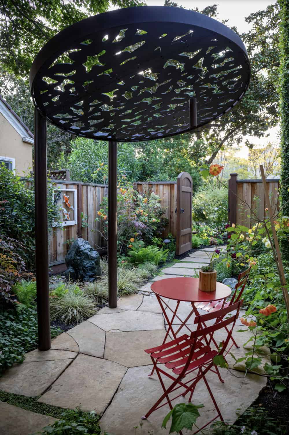 intimate patio sitting area with a custom arbor
