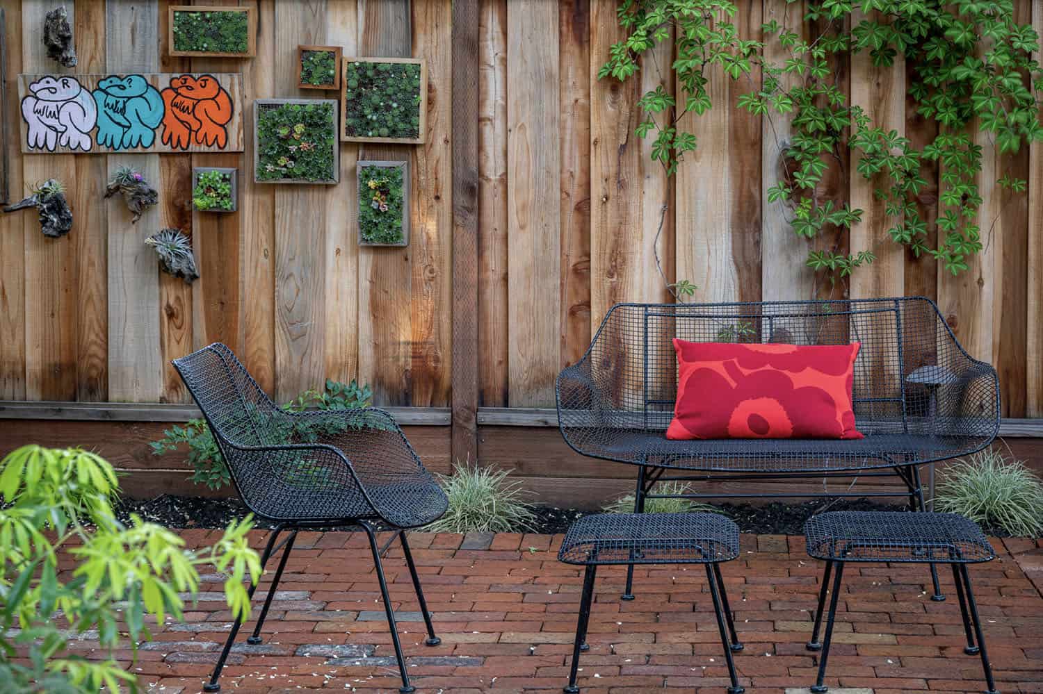 small patio with a privacy wall and framed succulents