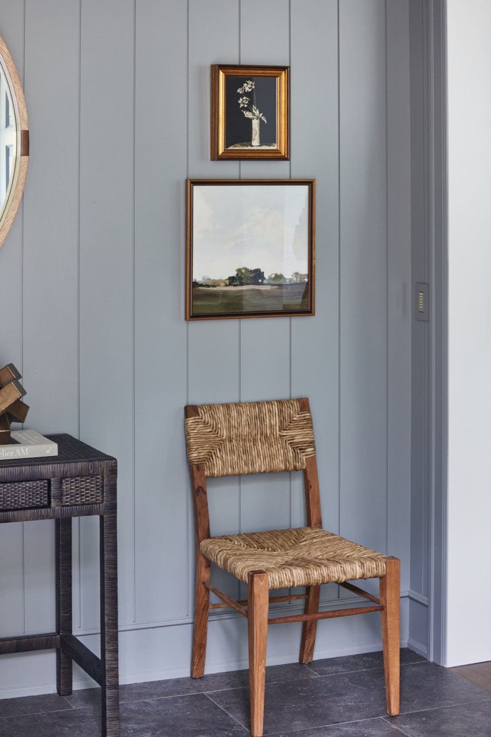 A chair and a mirror in a room with a wooden floor.