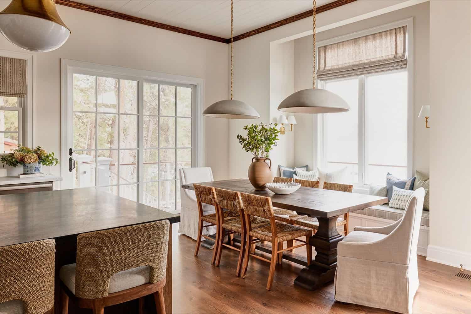 A kitchen with a dining table and chairs.