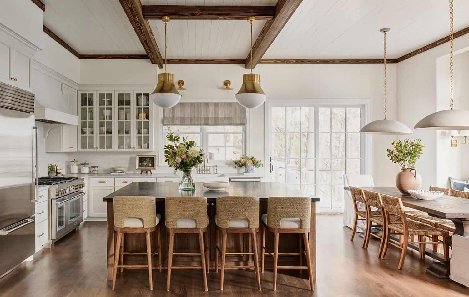 A kitchen with white cabinets and black counter tops.