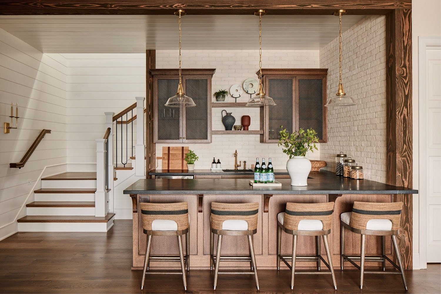A home bar with bar stools and a counter.