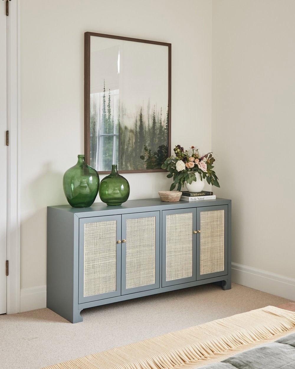 A bedroom with a large mirror and a wooden cabinet.