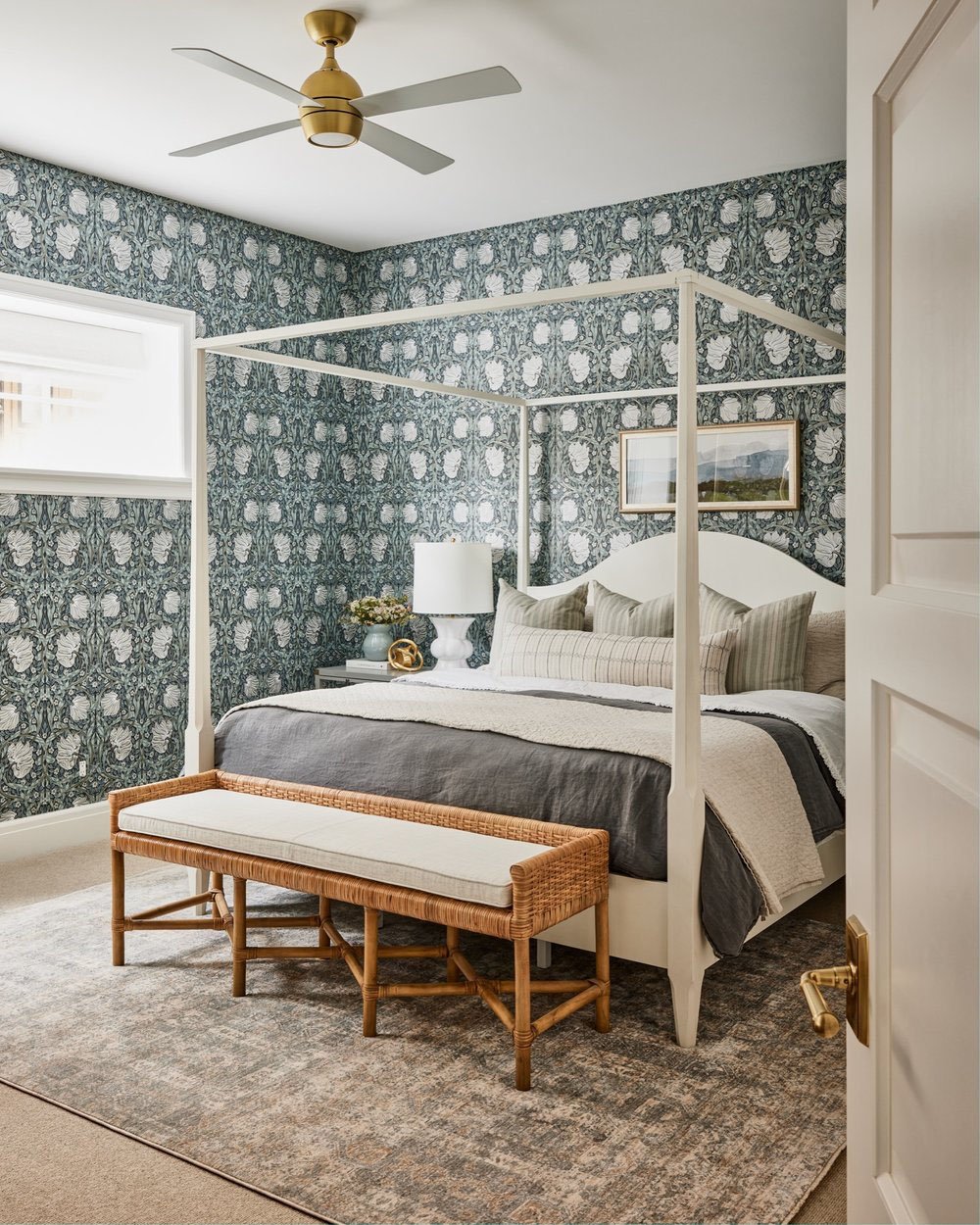 A blue and white floral wallpaper is on the wall.