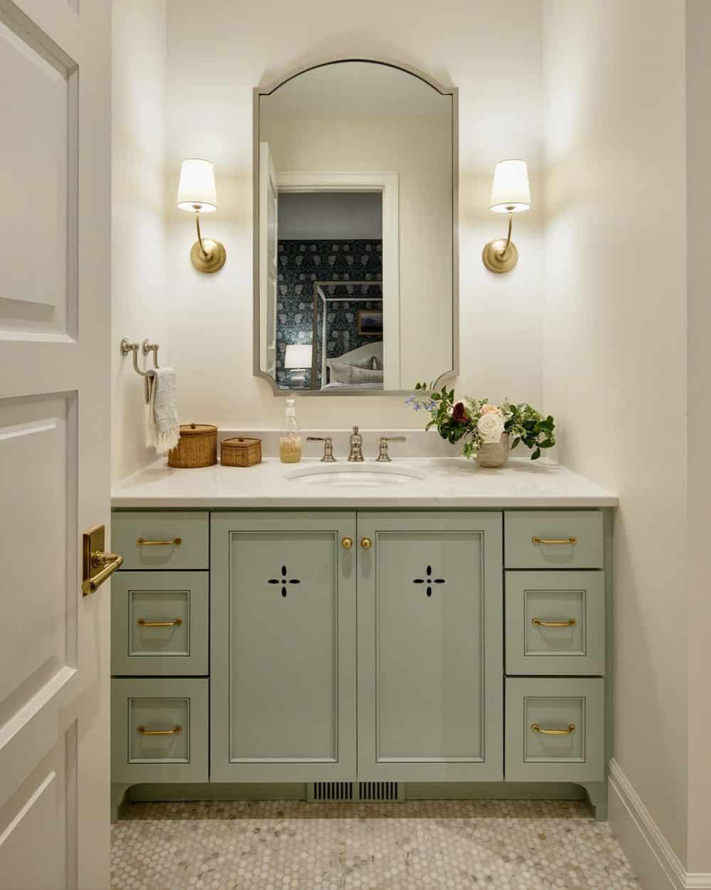 A bedroom with a mirror and wallpaper.
