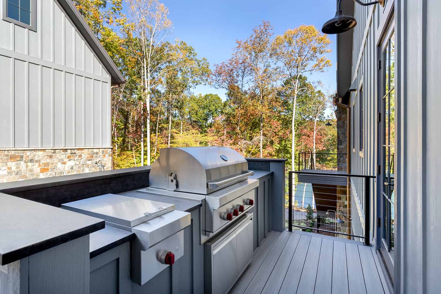contemporary lake house exterior deck with a grill