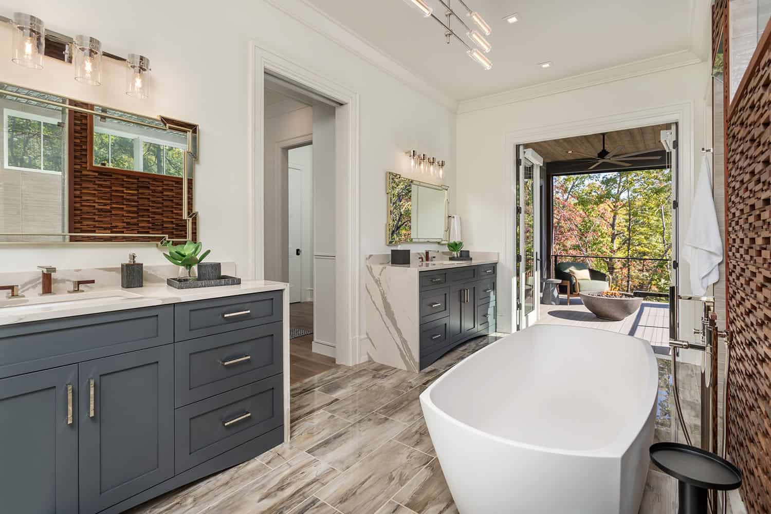 contemporary bathroom with dual vanities and freestanding tub