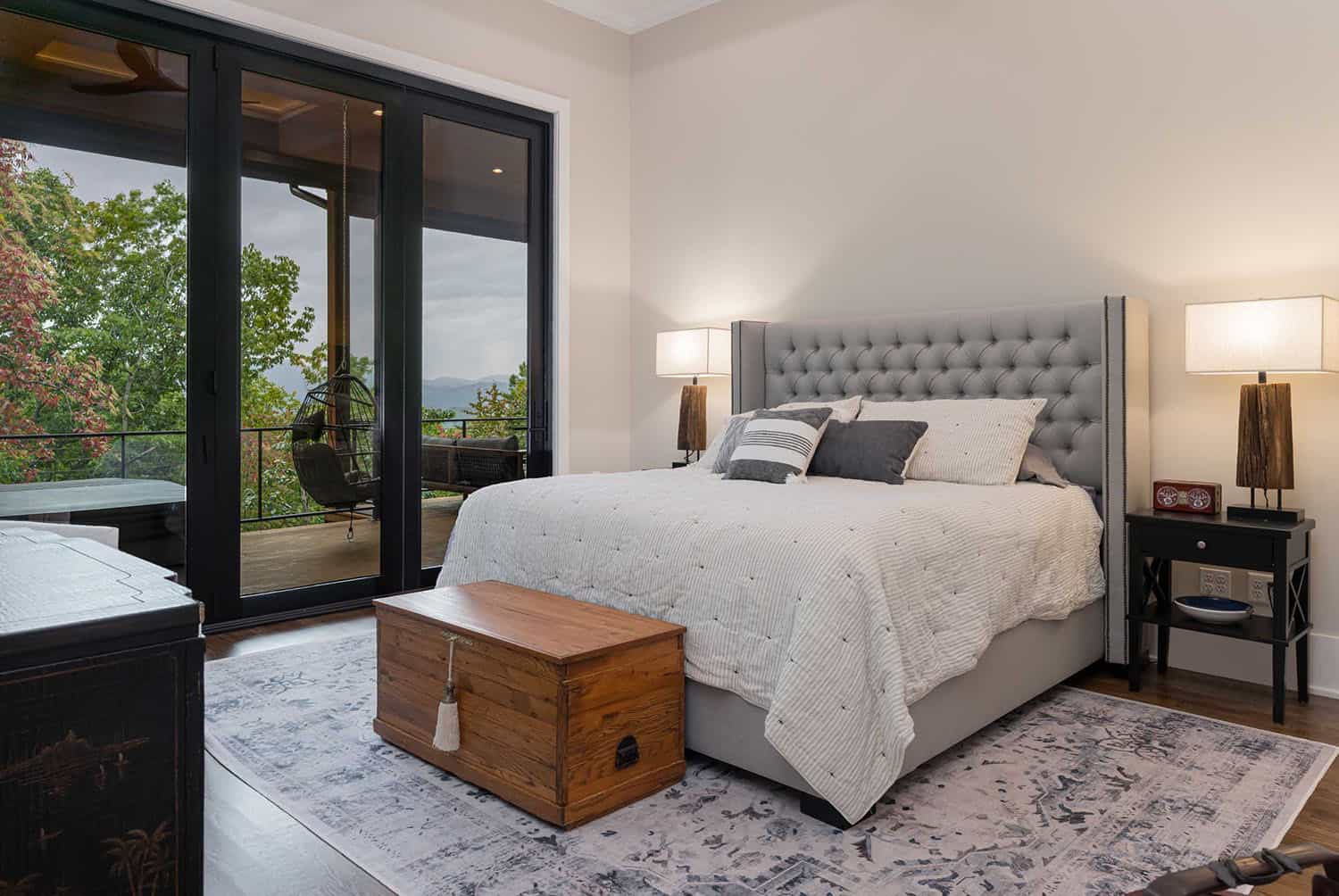 Contemporary bedroom with a sliding glass door leading out to a private balcony