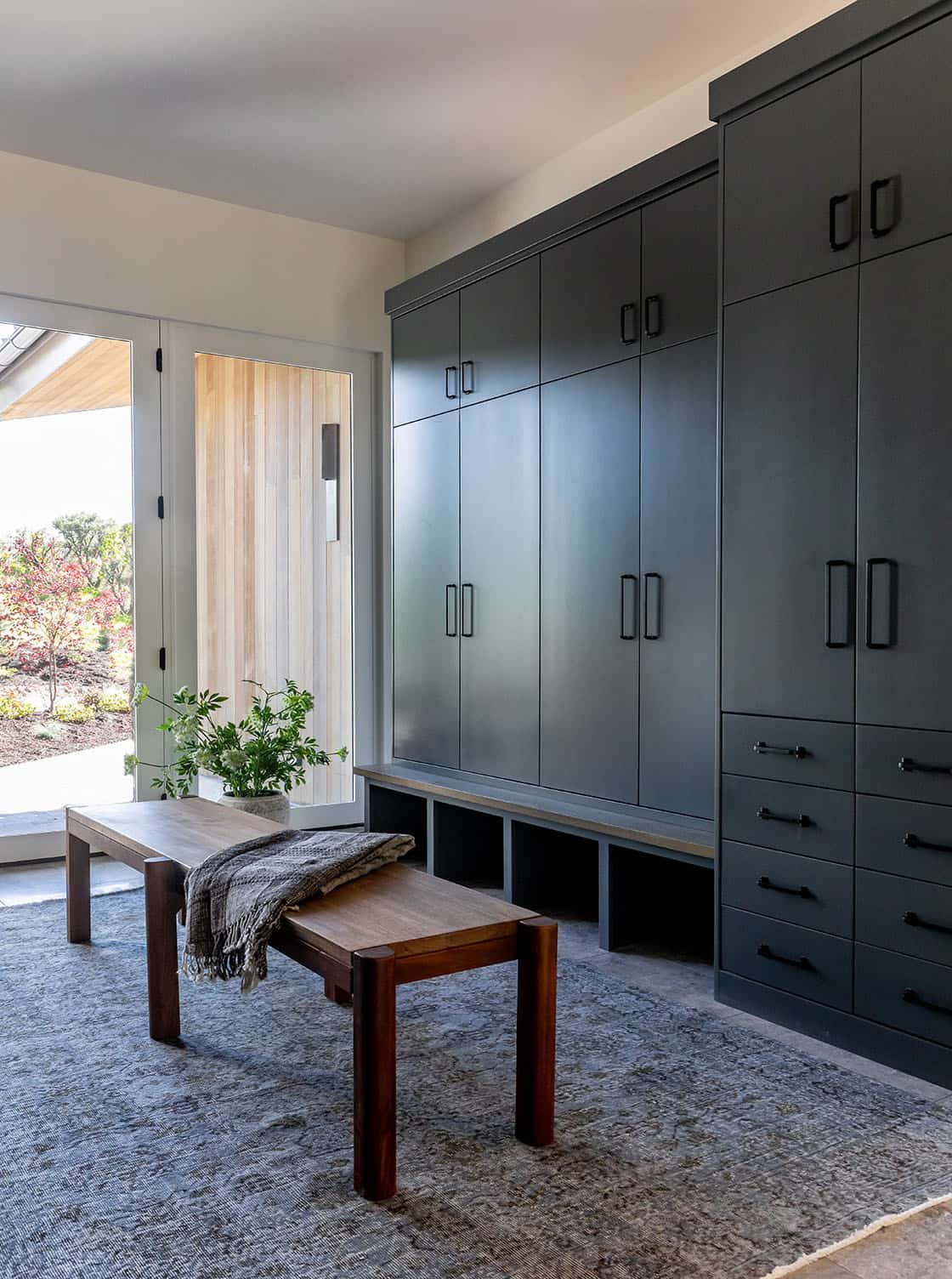 contemporary mudroom with a bench