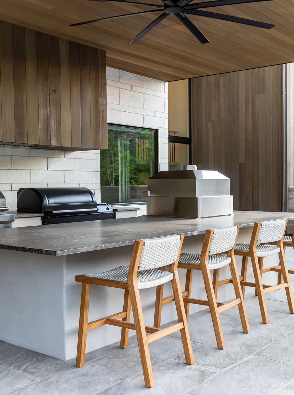 contemporary covered patio with an outdoor kitchen