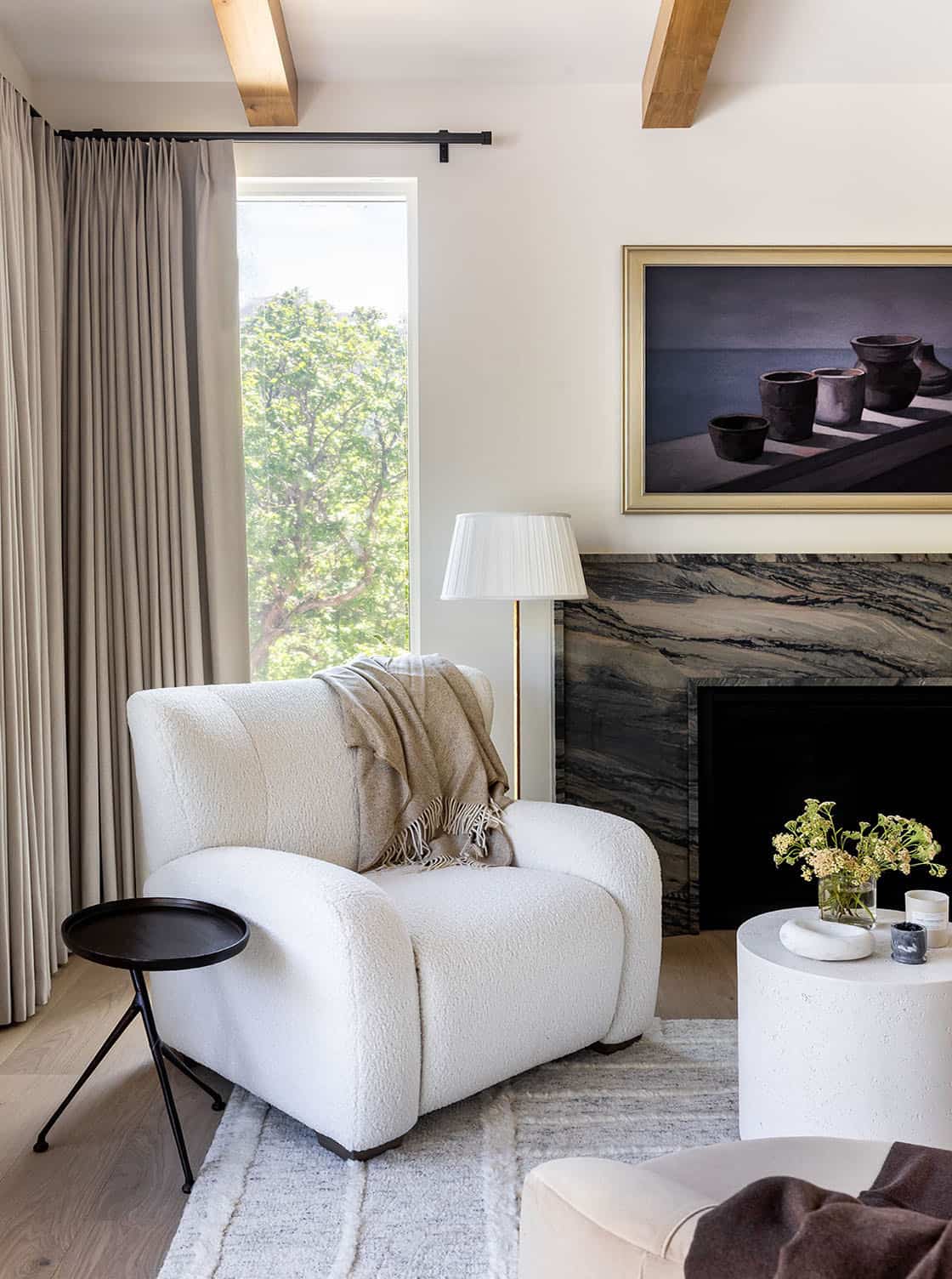 contemporary bedroom with a fireplace and sitting area