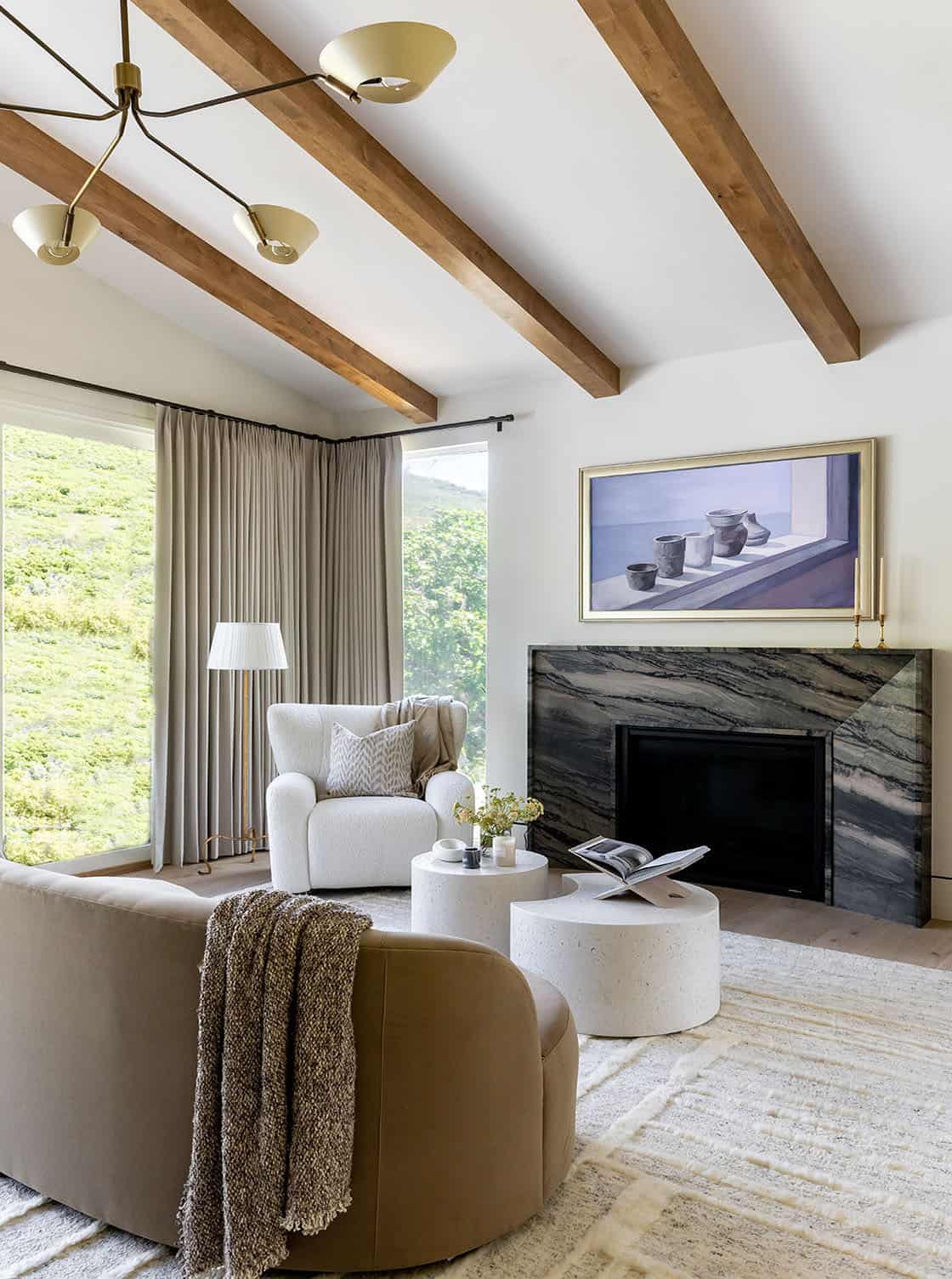 contemporary bedroom with a fireplace and sitting area