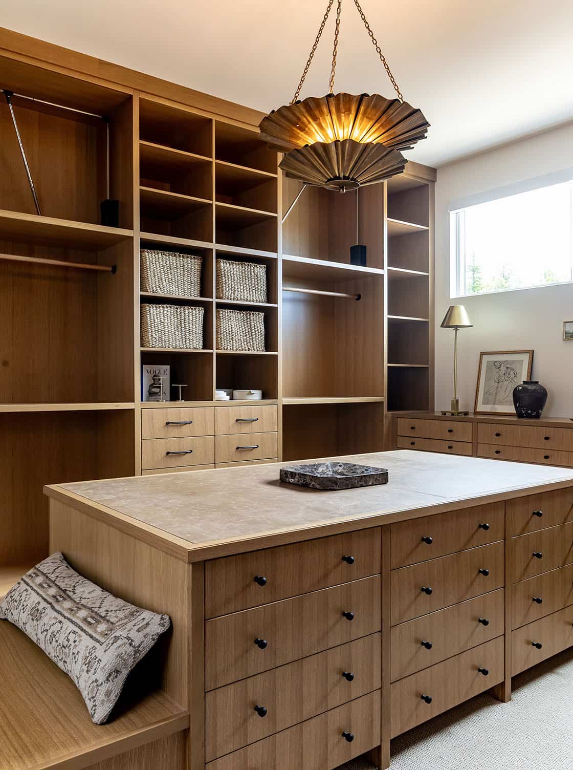 contemporary walk-in closet with an island and built-ins