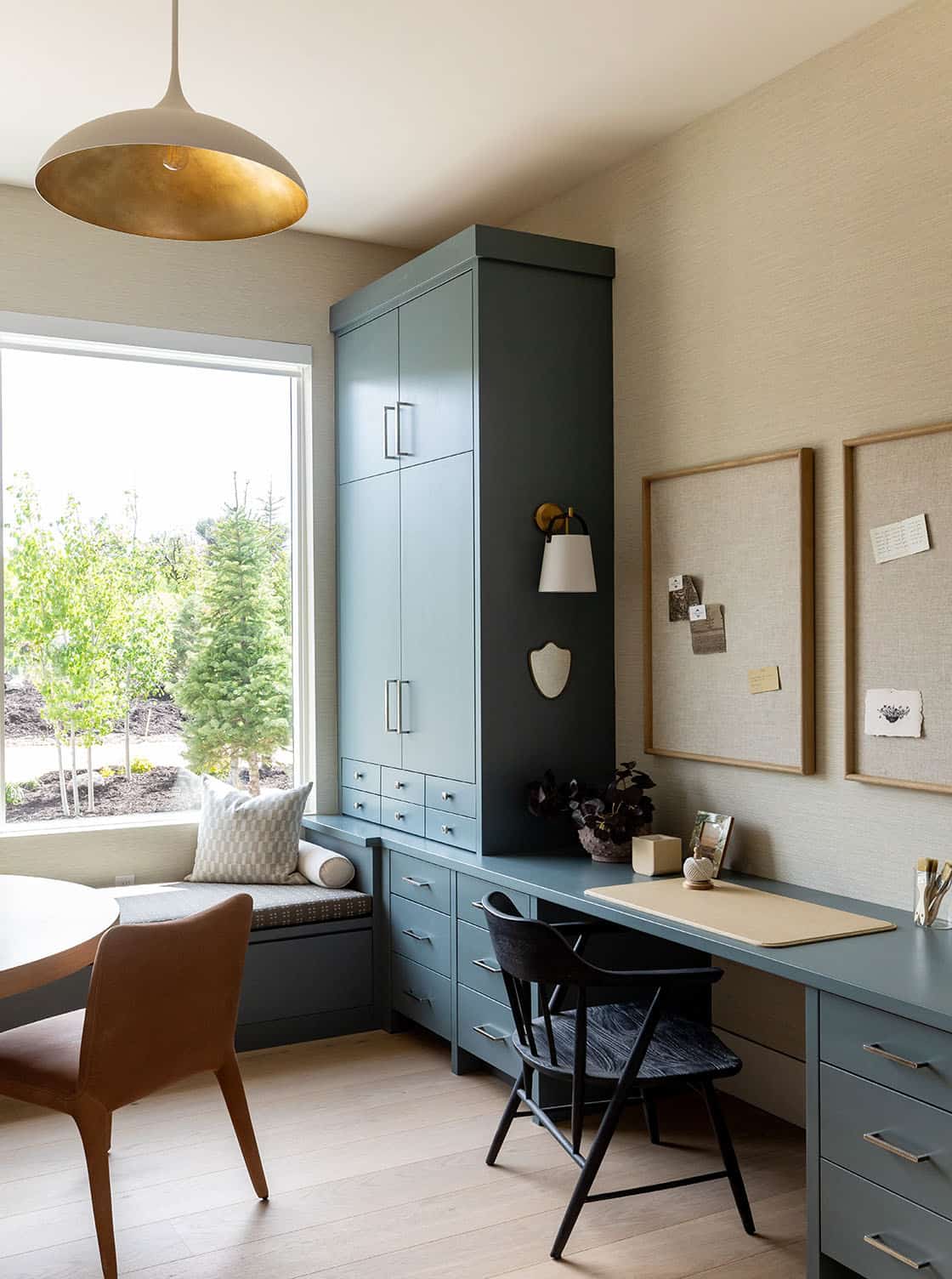 contemporary home office with a large window and built-in window seat