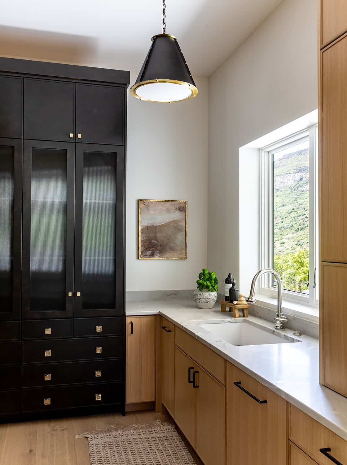 contemporary pantry with a sink and large window