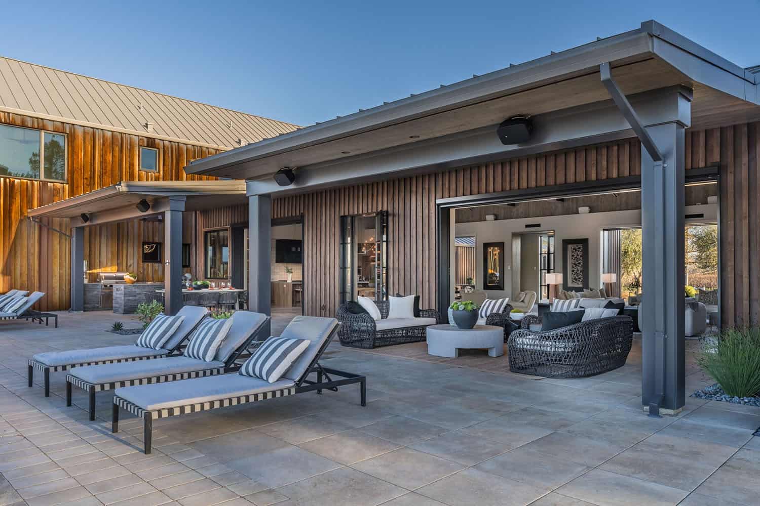 contemporary vineyard home exterior patio with chaise lounge chairs