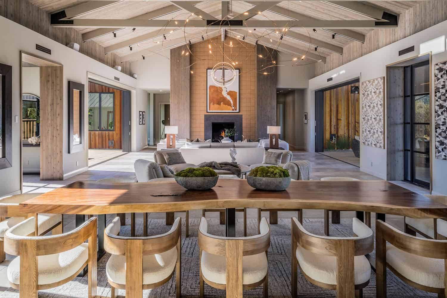 contemporary dining room and living room with a fireplace