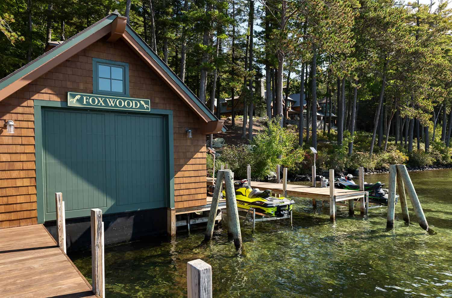 lake house exterior with a boat house and dock