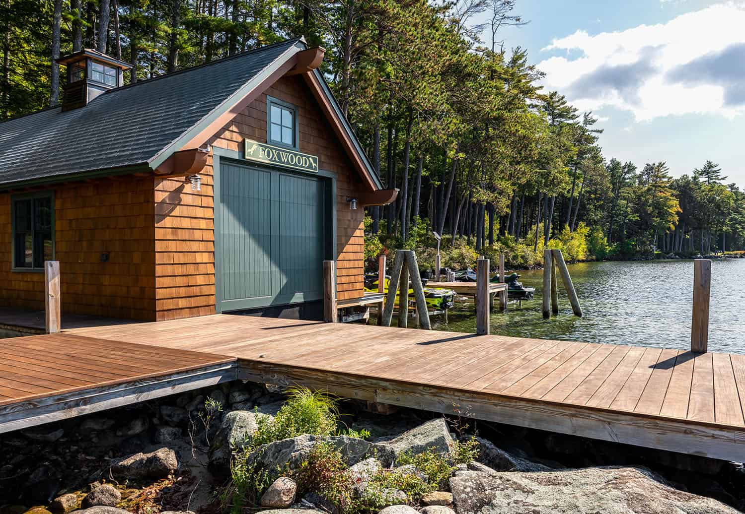 lake house exterior with a boat house and dock