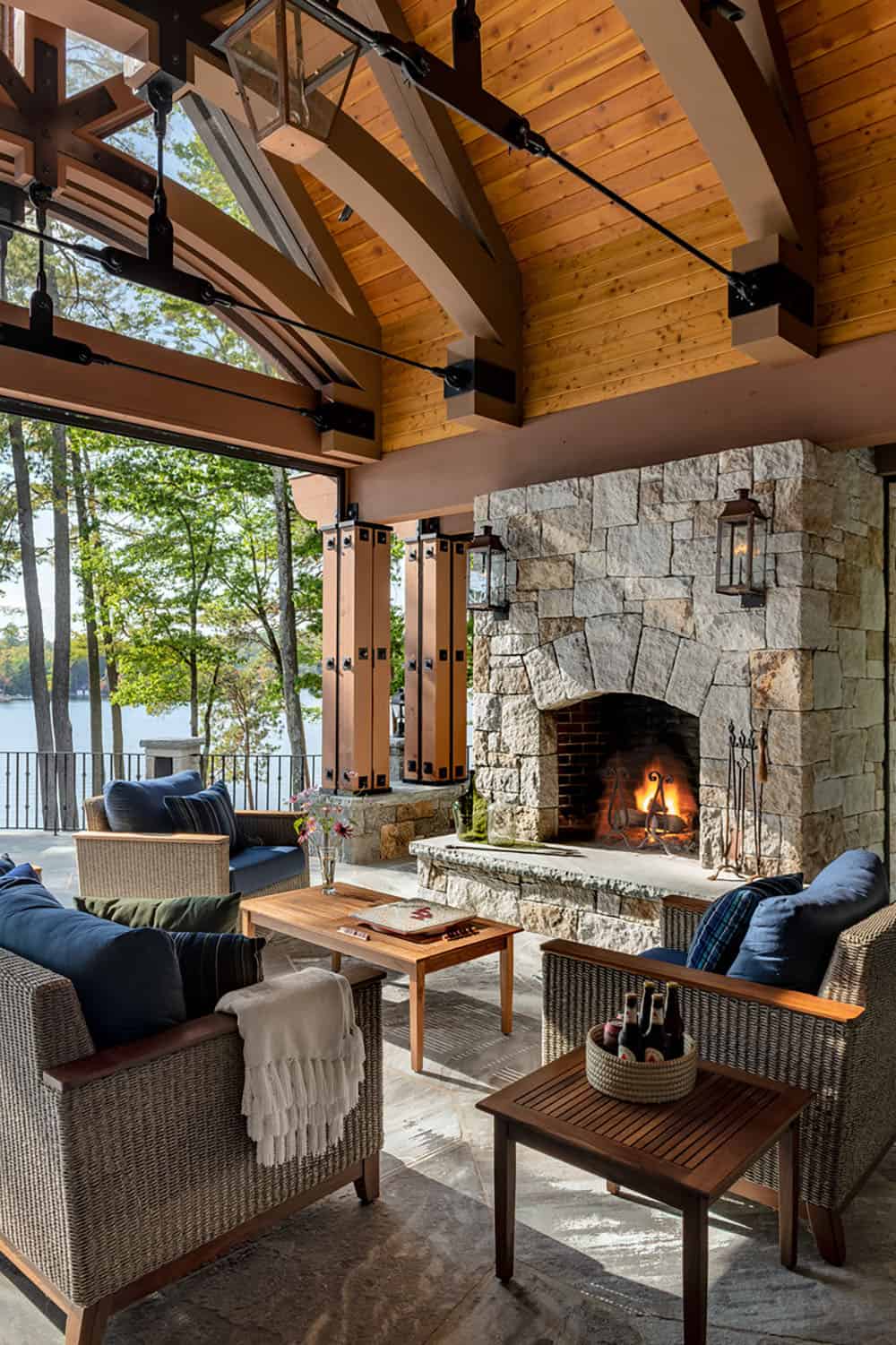 rustic covered porch with a fireplace