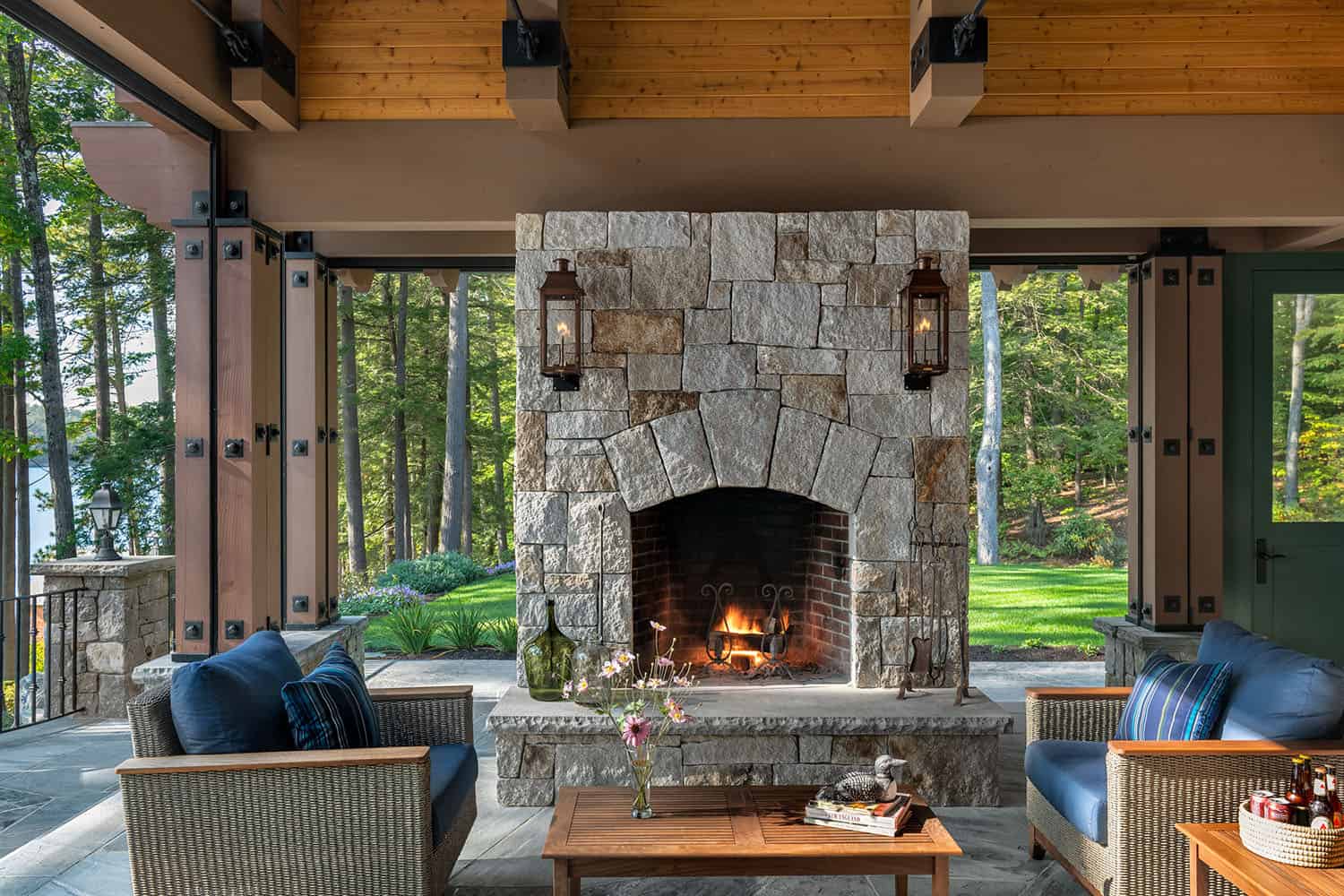rustic covered porch with a fireplace