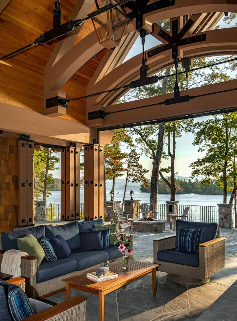 rustic lake house with a covered porch and outdoor furniture