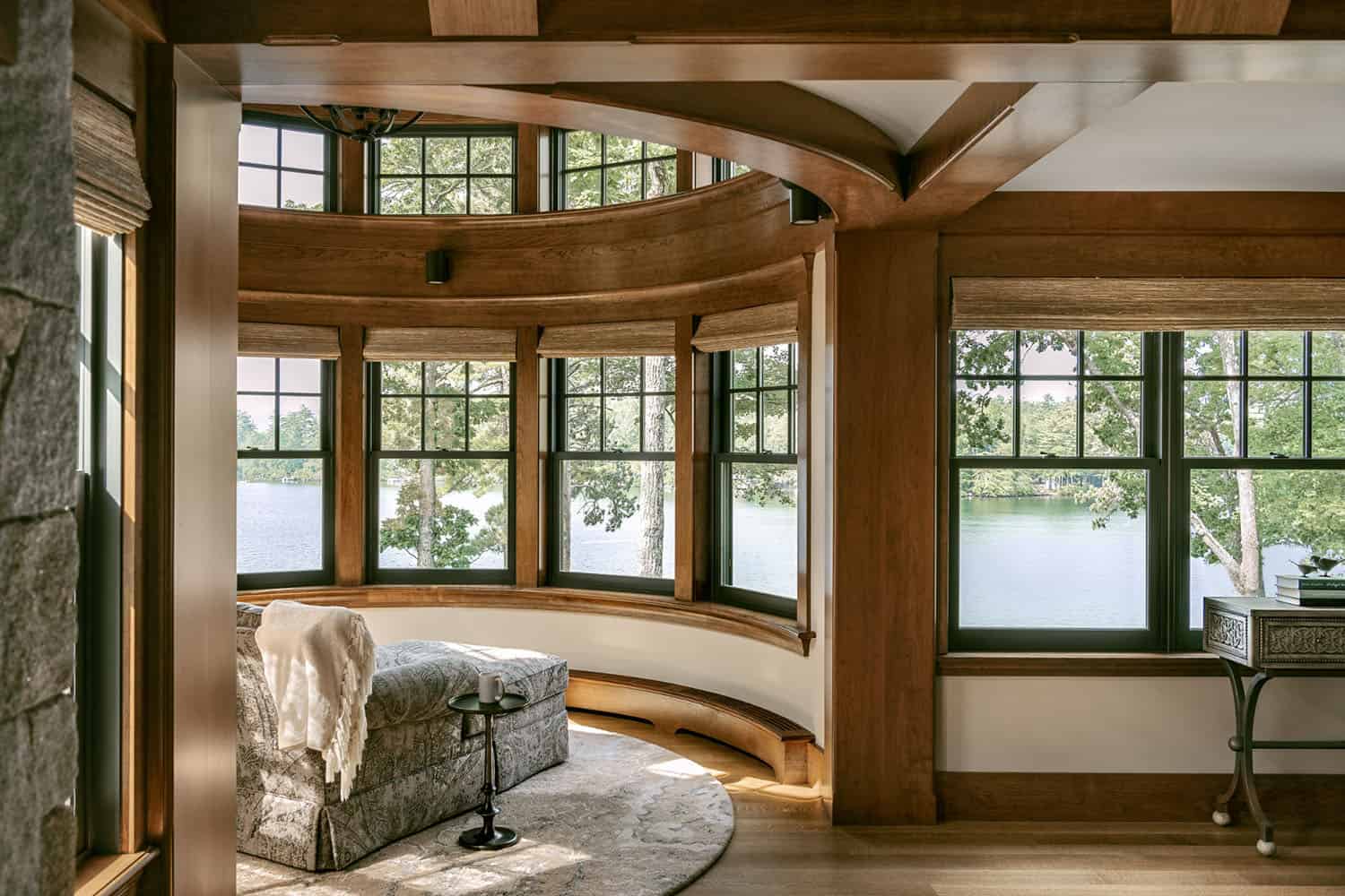 rustic bedroom with a chaise lounge in front of a window