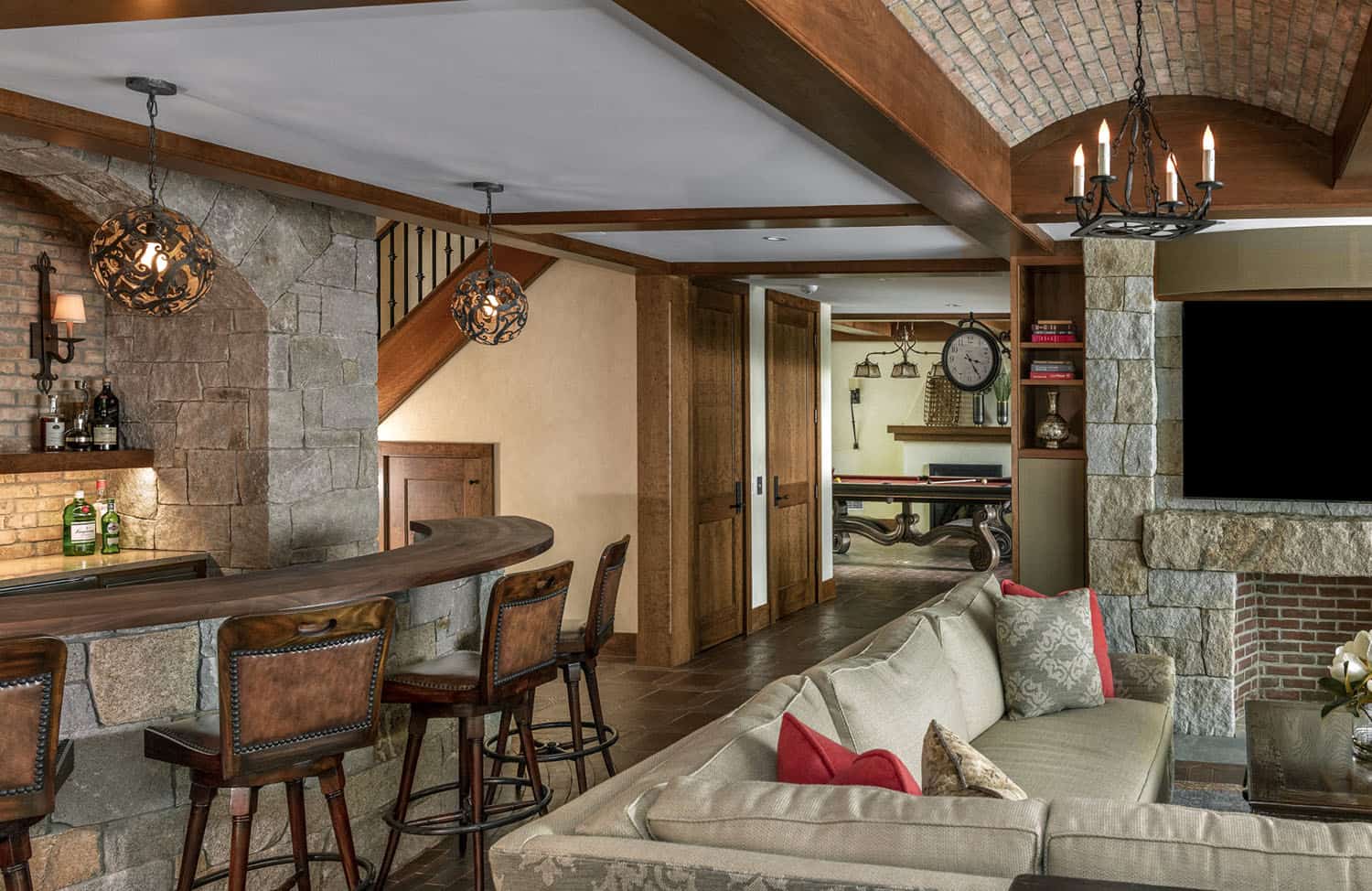 rustic lower-level family room with a home bar