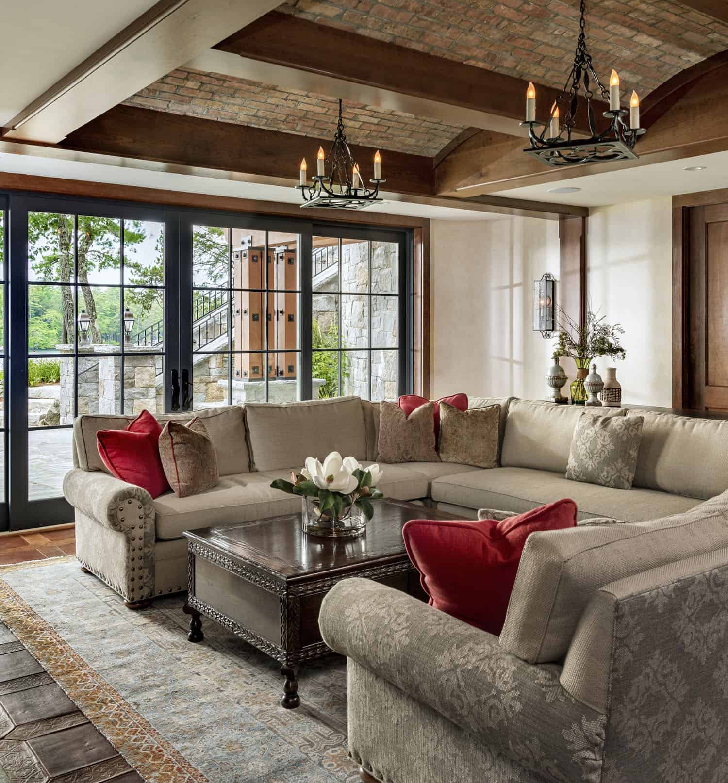 rustic lower-level family room with sliding glass doors leading out to a terrace