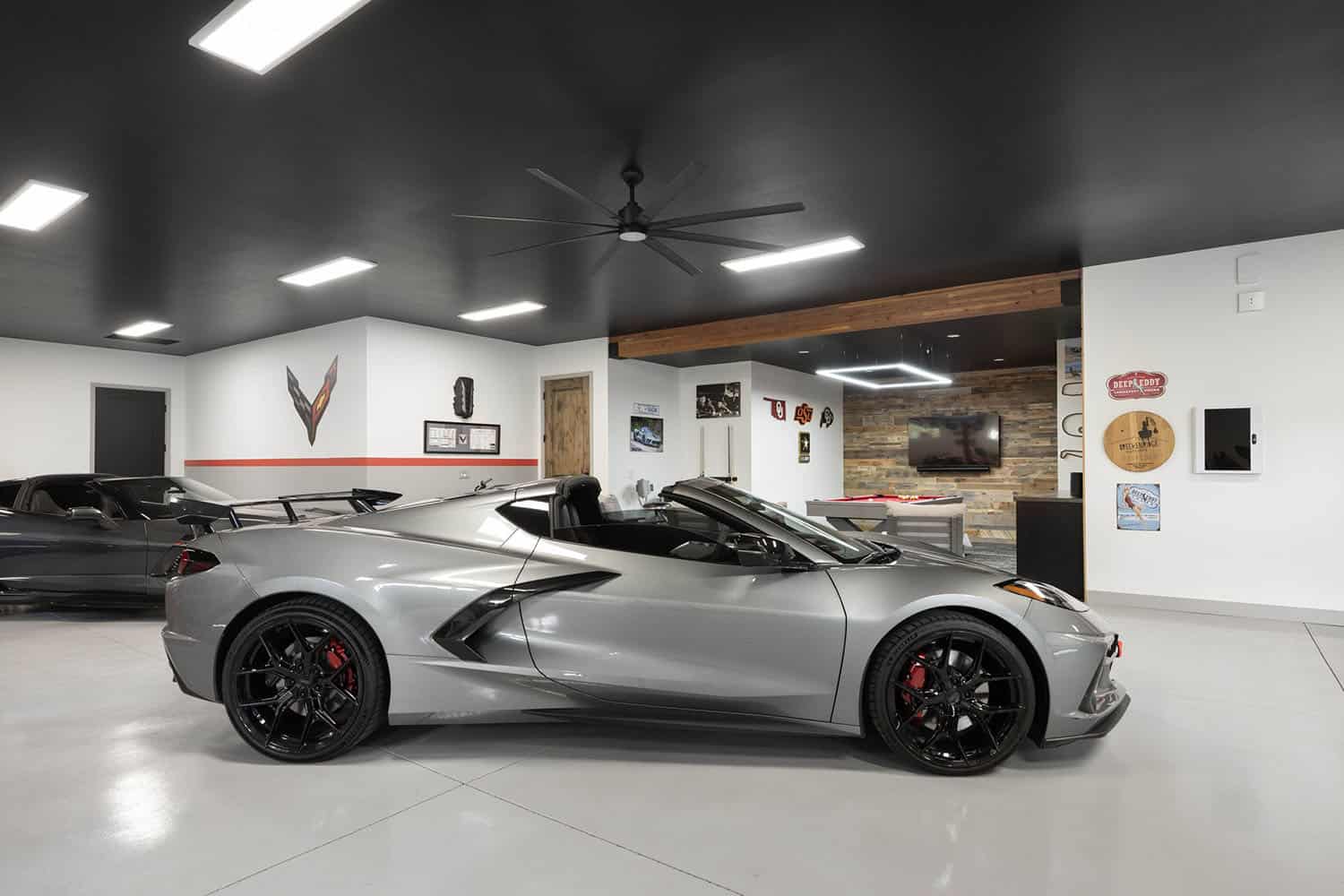 A silver corvette car in a garage.
