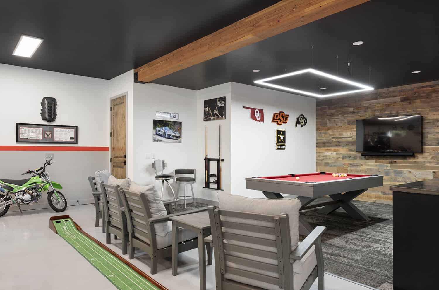 A modern living room with a stone fireplace and a ceiling fan.
