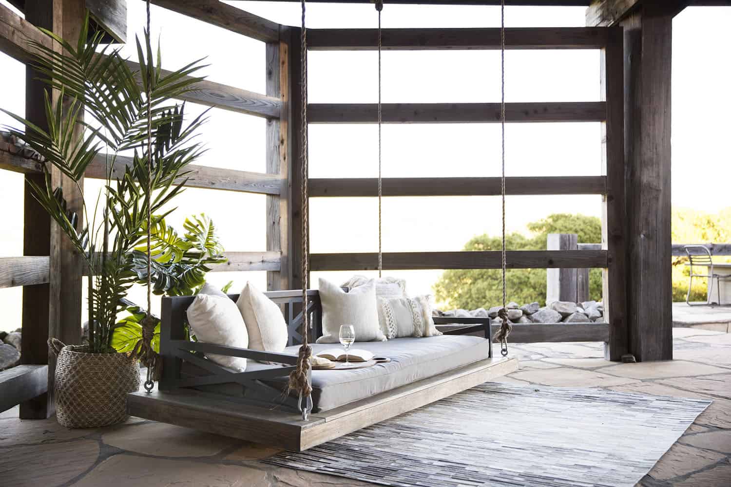 contemporary covered patio with a hanging daybed