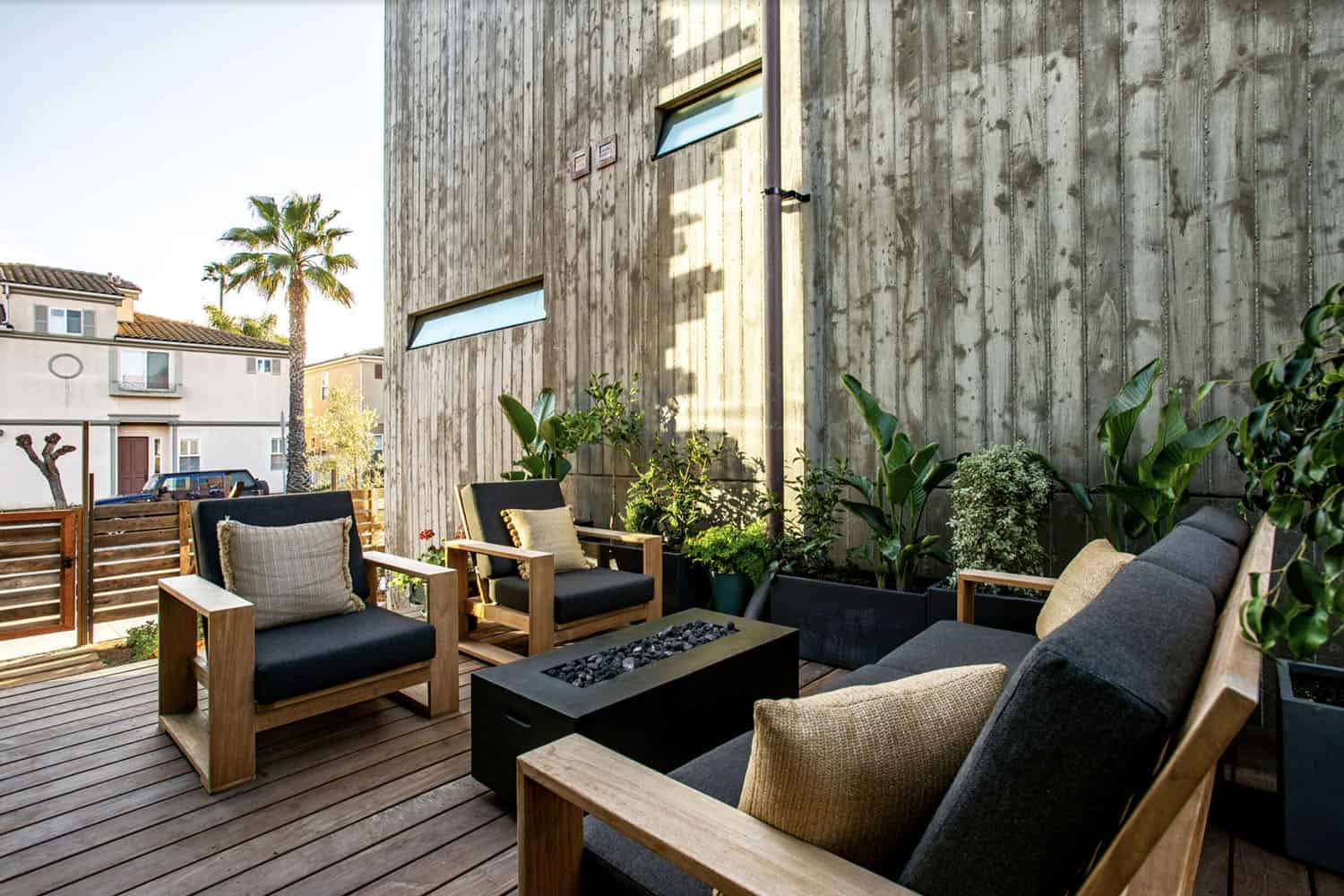 industrial style house exterior patio with outdoor furniture and a fire pit