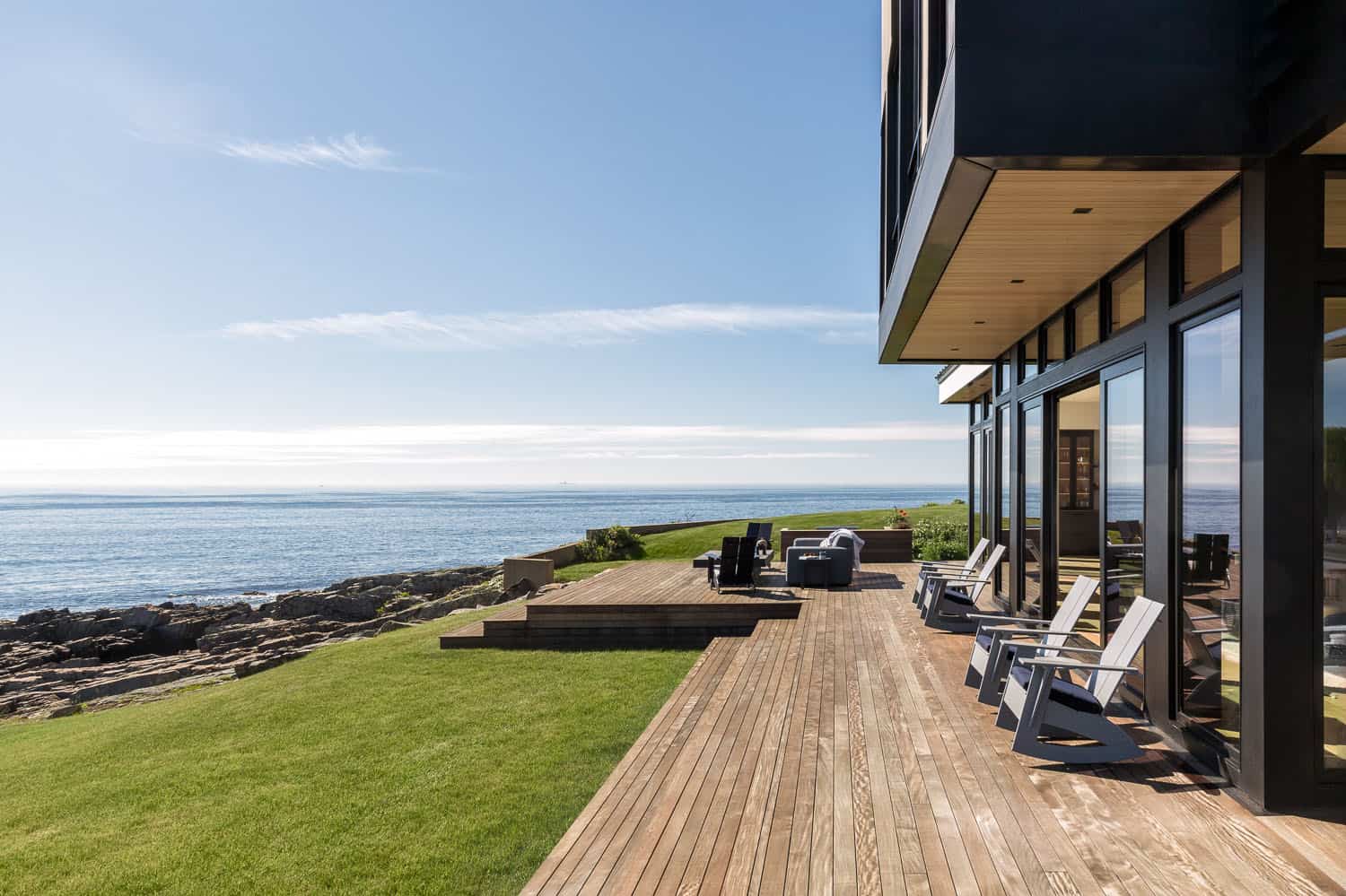 modern coastal home exterior with a deck