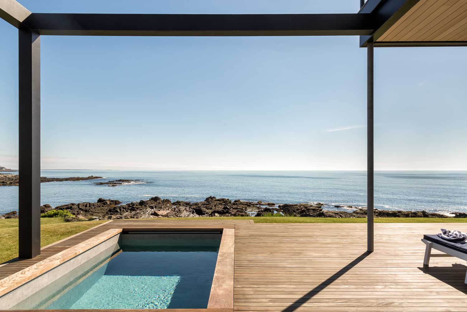 modern coastal home exterior with a pool