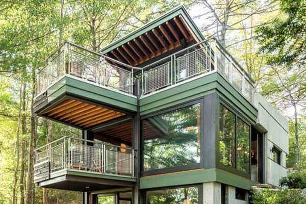 featured posts image for This lakeside refuge in Maine cantilevers over a peaceful forest setting
