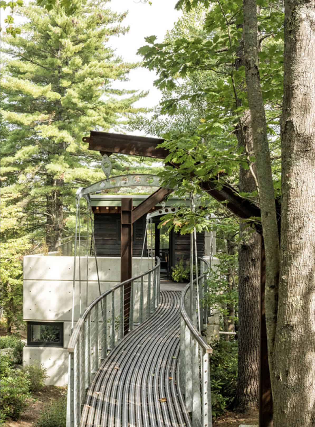 lake house exterior with a suspension bridge