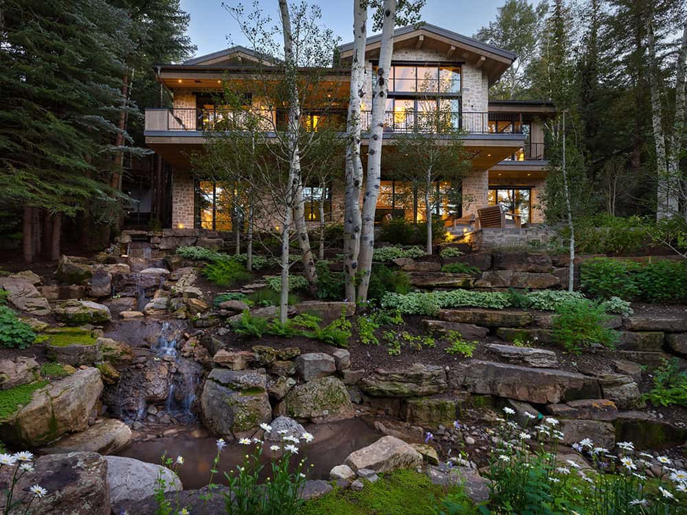contemporary mountain home exterior with a stream