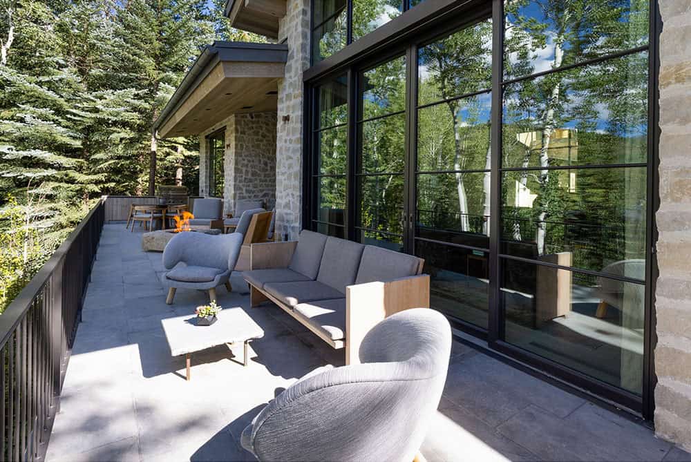 contemporary mountain home exterior with a patio and outdoor furniture