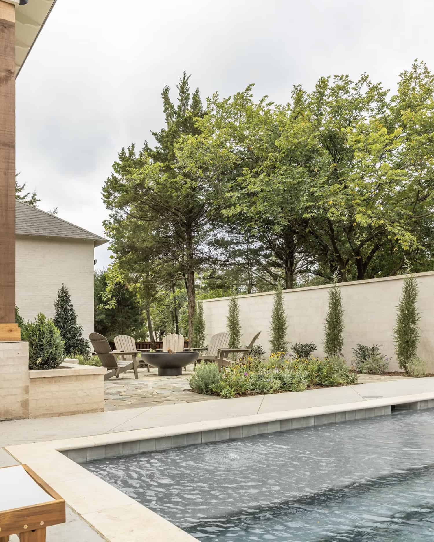 luxury european cottage style home exterior backyard with a pool