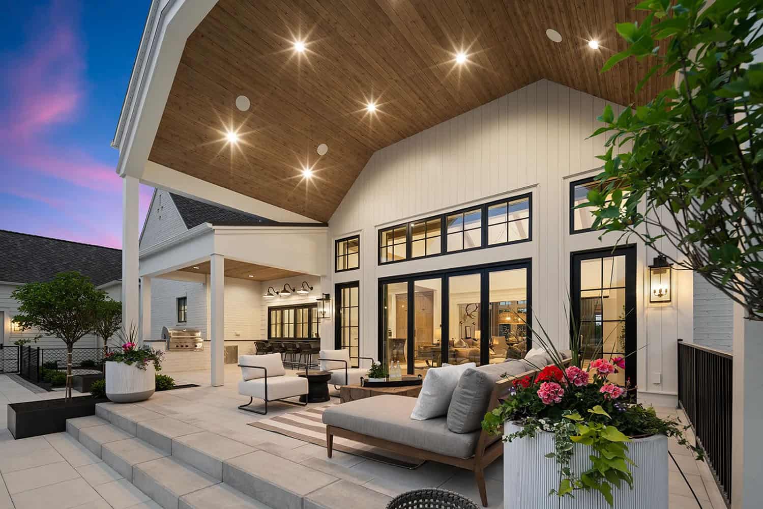 european style home exterior with a covered patio and outdoor furniture