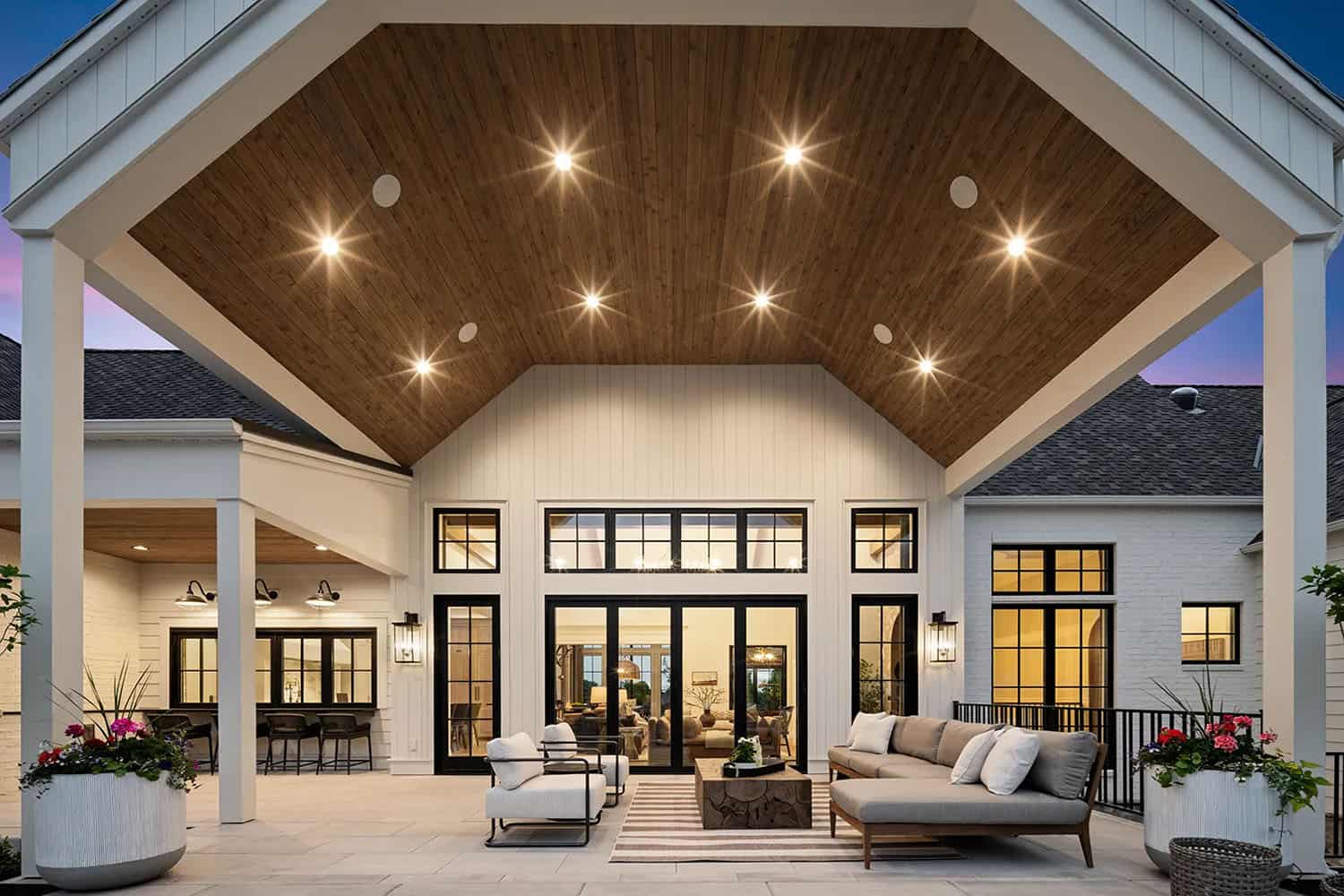 european style home exterior with a covered patio and outdoor furniture
