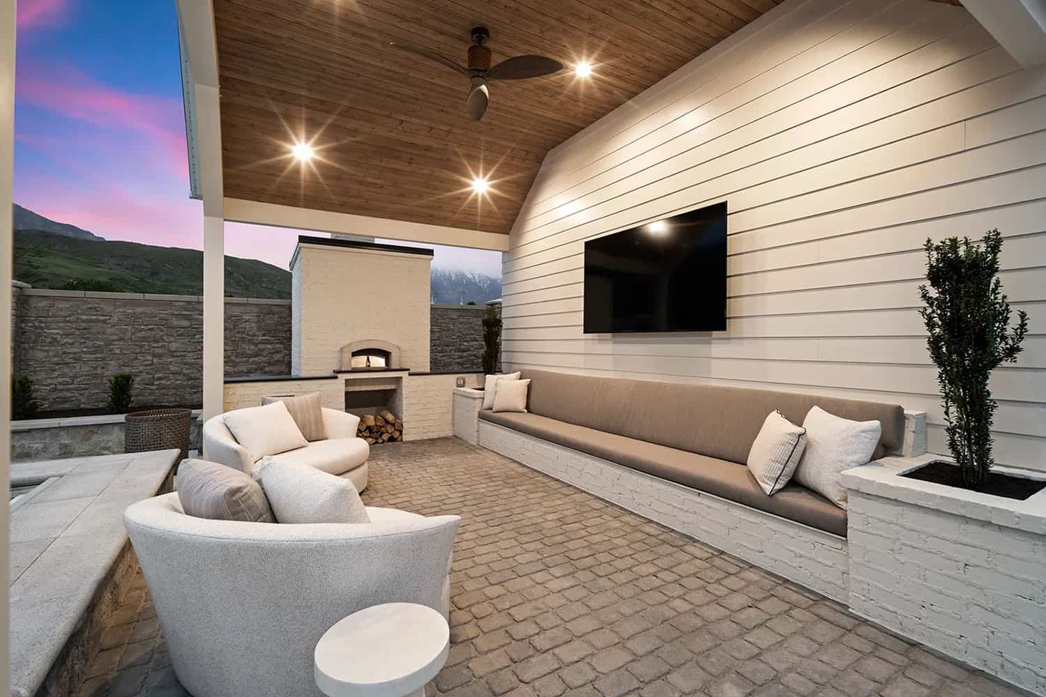 european style home exterior with a covered patio and outdoor furniture