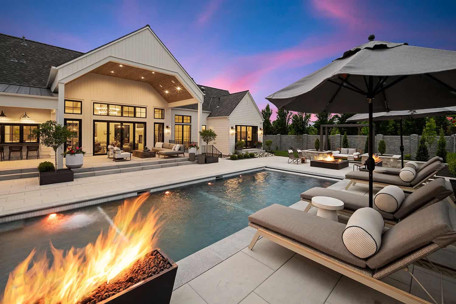 european style home exterior patio with a fire pit and pool